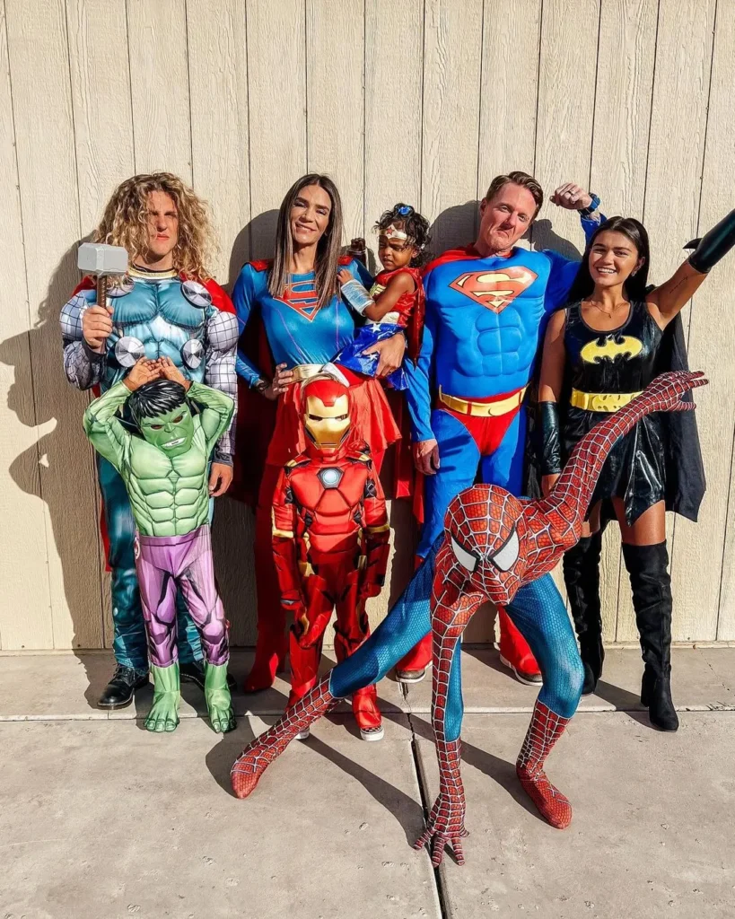 family of 7 Halloween costumes with superheroes